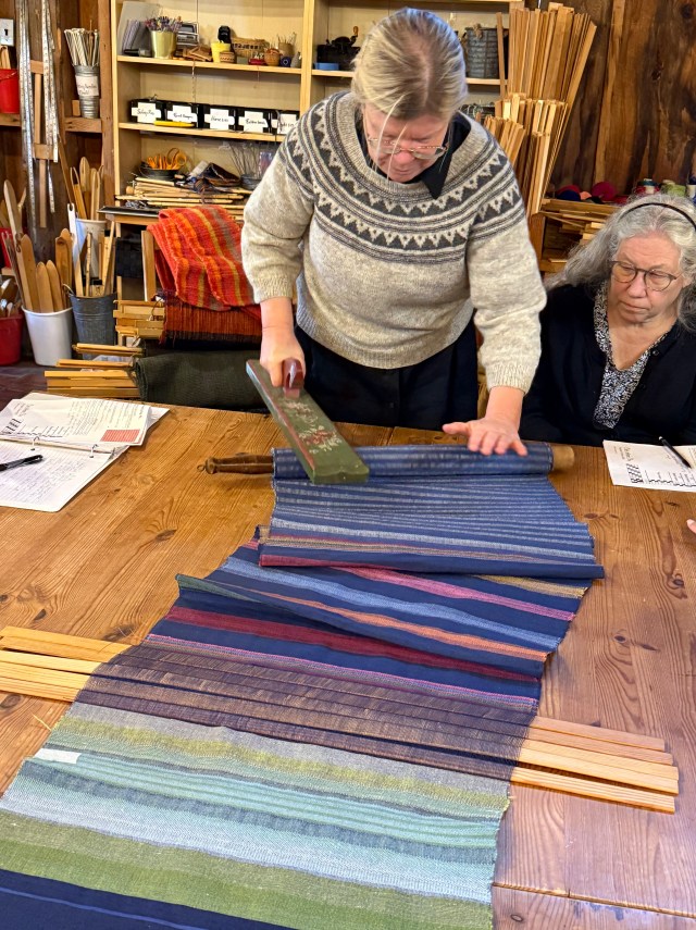 Tina Ignell mangling linen with a traditional board and pin